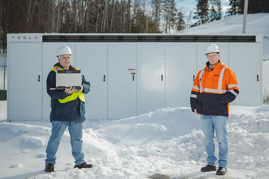 2 employees in the snow working