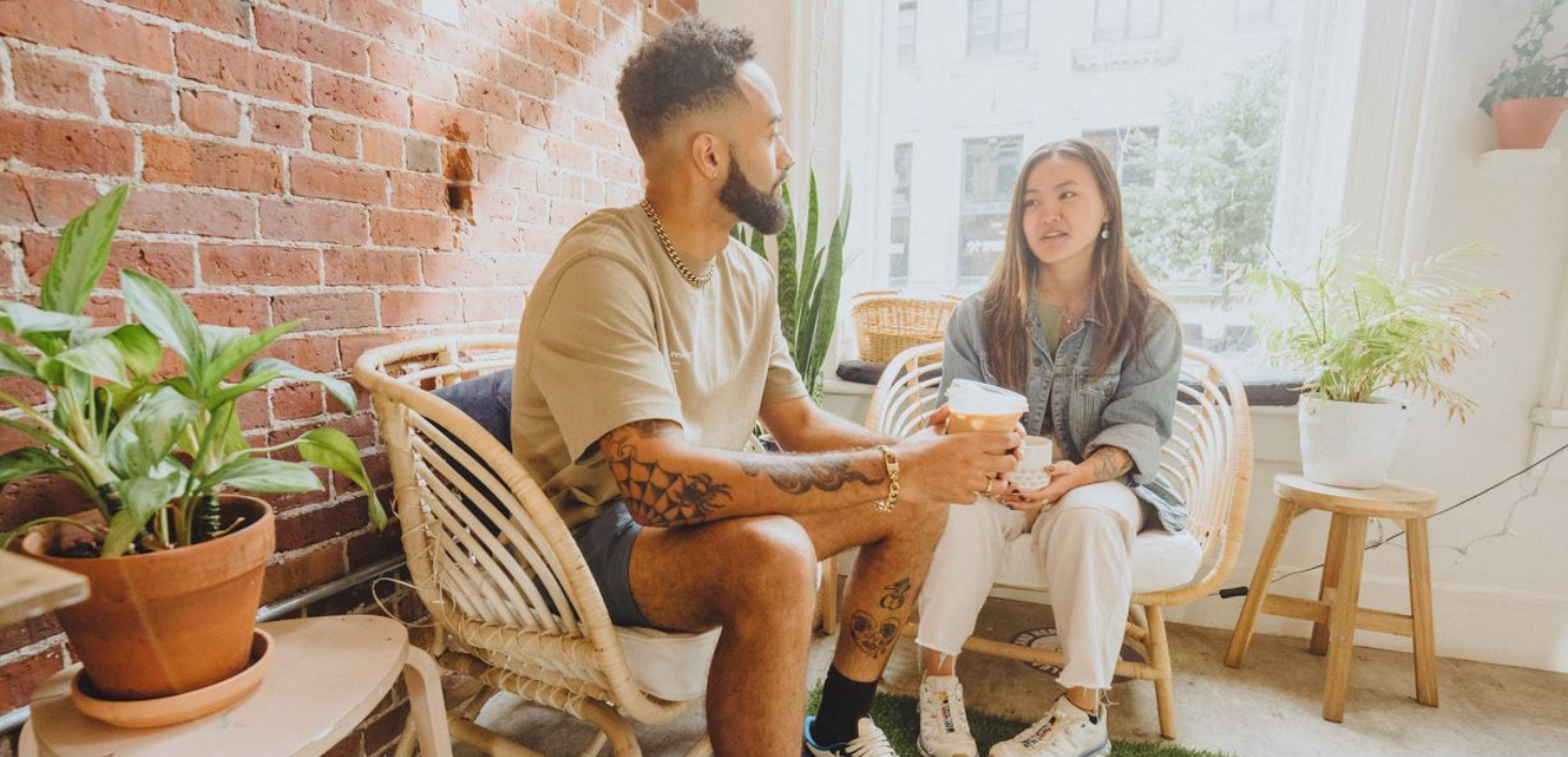 man and woman sitting having coffee 