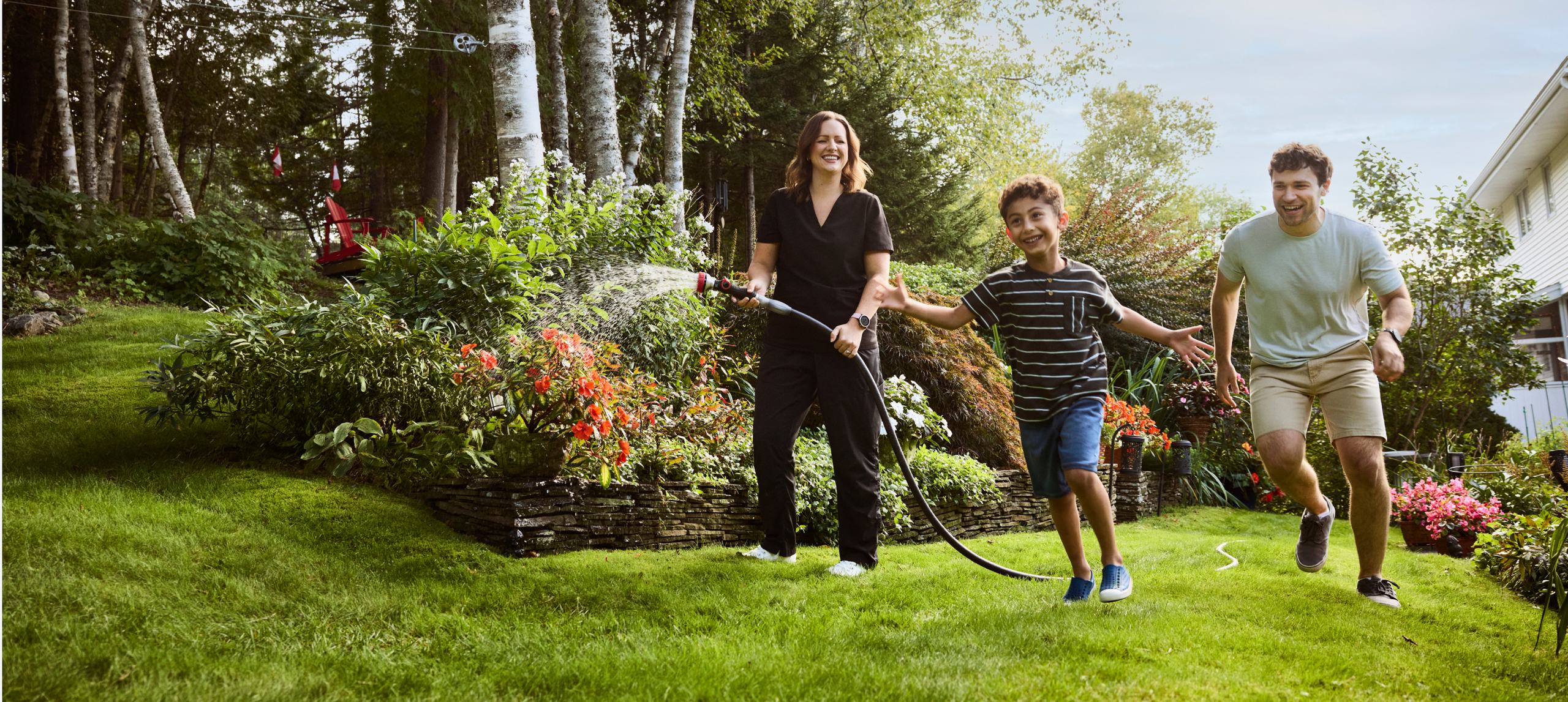 A family laughing together in their backyard garden