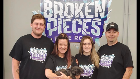 family in front of business sign