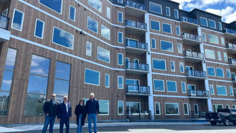 a group of developers standing in front of new construction 