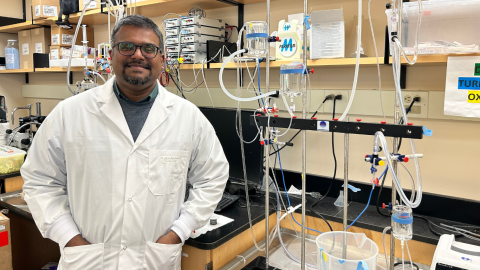 man standing in research centre with lab coat 